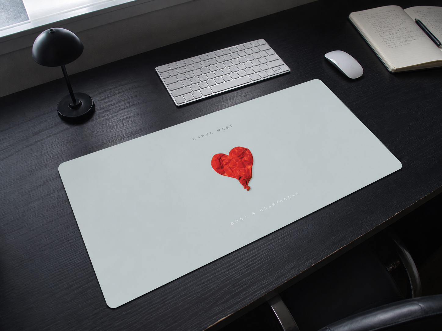 808s & Heartbreak Album Pad on a minimal black desk